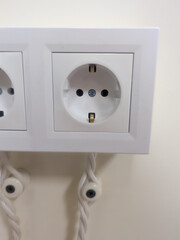 a pair of white sockets on the wall