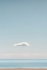 Poster - A solitary cloud floating in the sky over the calm ocean, symbolizing tranquility, minimalism, and peacefulness with soft pastel colors blending into the water below