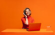 © Jacob Lund - Happy call center agent in a vibrant monochromatic orange workspace, emphasizing creativity and customer care