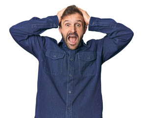 Wall Mural - Studio portrait of young Hispanic male screaming, very excited, passionate, satisfied with something.