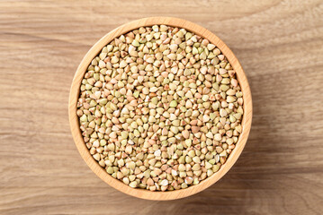 Wall Mural - Organic buckwheat seed in bowl on wooden background, Food ingredient, Table top view