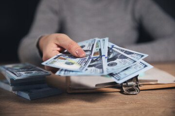 Wall Mural - business hands holding dollar