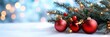 © Inlovehem - Christmas decorations with red baubles and a pine branch on a snowy background, creating a festive atmosphere.