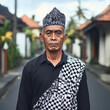 © Anantaraya - Balinese elder in traditional attire amidst a serene village ambiance