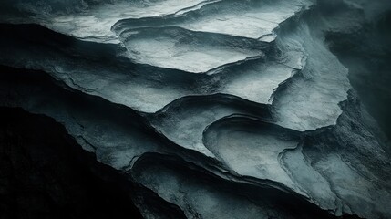 Poster - Aerial view of dark, textured canyon rock formations, misty background, geological texture