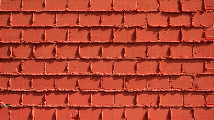 Wall Mural - The photograph shows a close-up of an orange brick wall