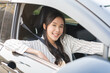 © KMPZZZ - Transport concept, happy smile brunette hair asian young woman driving, getting new car, vehicle for travel, trip with face positive, female driver car with fasten safety seat belt before traveling.