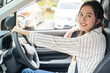 © KMPZZZ - Transport concept, happy smile brunette hair asian young woman driving, getting new car, vehicle for travel, trip with face positive, female driver car with fasten safety seat belt before traveling.