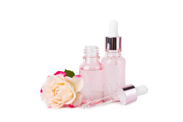 Wall Mural - Rose essential oil isolated on white background.Roses and a bottle of rose perfumed water. Aromatherapy treatment. Beauty concept. Spa procedure.Natural organic oil.Anti-stress and detox relax.