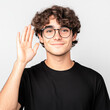 © Kowit - Young man smiling in indoor portrait photography at eye-level connection