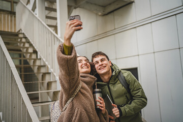 Wall Mural - beautiful couple take a self portrait or have video call on cellphone