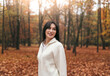 © ADDICTIVE STOCK - Woman in autumn forest surrounded by vibrant fall leaves
