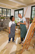 © Caia Image - Disabled people talking in art studio