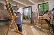 © Caia Image - Disabled people painting during art class