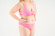 © staras - Fat woman in pink underwear on gray background, overweight female, obesity body, weight loss concept with copy space