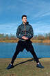 © ADDICTIVE STOCK - Outdoor fitness, man in sportswear by a lake on a sunny day