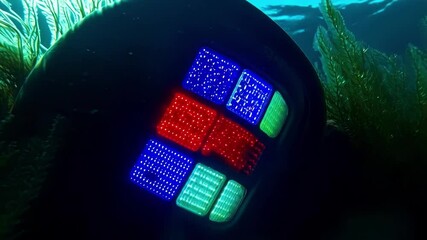 Poster - electronic underwater technological device gradually illuminating red, green, and blue led panels wh