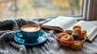 © salonfoto - A cozy autumn scene with a hot coffee and pastries by the window. Enjoying the beautiful fall view with a book and snacks.