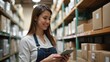 © useful pictures - Smiling Woman Checks Inventory on Her Smartphone in a Tidy Warehouse, Highlighting Logistics and Supply Chain Management