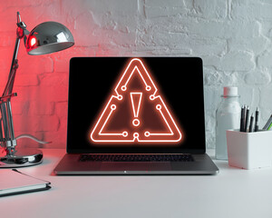 Poster - A detailed image of a laptop with a warning alert symbol on the screen, surrounded by a desk lamp and office supplies, representing online threat, cybersecurity, and digital safety.