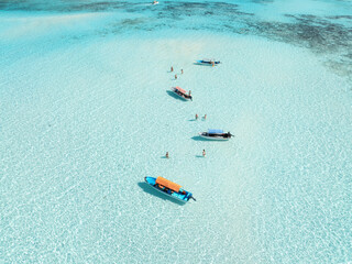Wall Mural - aerial view of colorful boats, sea bay with azure water on summer day. mnemba island, zanzibar. top 