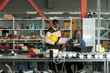 Aufkleber - Young male engineer with lamp and his boss with working documents discussing principles of equipment work