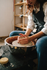 Fototapete - Process of making a unique ceramic shape. Potter creates a ceramic bowl in the pottery studio.
