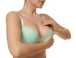© New Africa - Woman wearing beautiful bra on white background, closeup