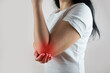 © Tania - Woman having elbow ache at home, muscle pain due to lateral epicondylitis or tennis elbow. injury, Health and medical concept