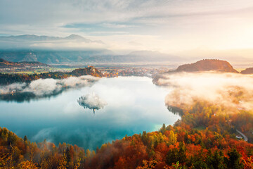 Wall Mural - Aerial view of the alpine Lake Bled covered in morning mist from the Osojnica viewpoint. Location place Julian Alps, Triglav national park, Slovenia, Europe.