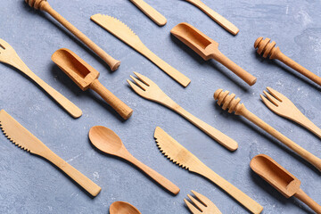 Wall Mural - Different wooden kitchen utensils on blue background