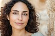 Serene hispanic female adult with natural curly hair in sunlit outdoor setting