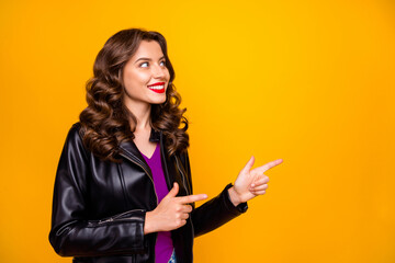 Wall Mural - Photo of pretty lady indicating fingers empty space at low prices final sale wear leather jacket isolated yellow background