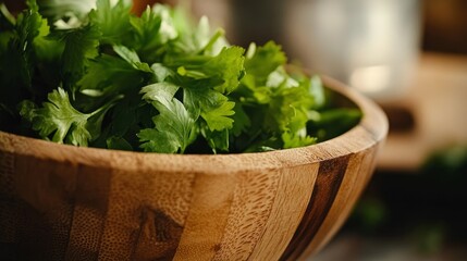 Wall Mural - plucked coriander leaves in a wooden bowl with visible grains of the used utensil