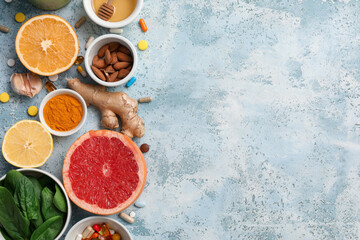 Wall Mural - Composition with different healthy food and pills on color grunge background. Immunity boosting concept