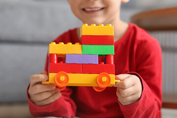 Canvas Print - Happy cute little boy with colorful bricks toy at home, closeup