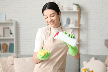 Poster - Young woman with detergent and sponge in living room