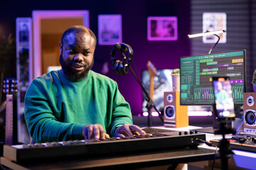 Poster - Artist songwriter hosting online master class to teach piano lessons on internet vlog, explaining electronic keyboard notes in his home studio. Young composer playing on synthesizer, recording video.