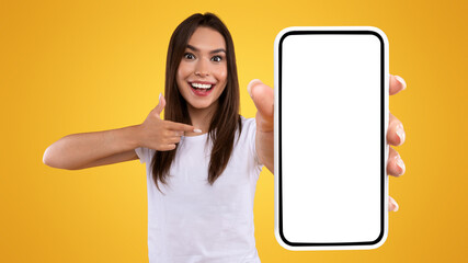 Aufkleber - Mobile Advertisement. Excited Lady Pointing On Smartphone With Blank Screen, Emotional Surprised Woman Recommending New Application Or Website, Presenting Device Display On Orange Background, Mockup