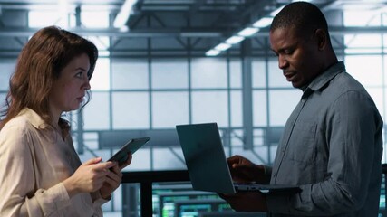 Poster - portrait of happy system administrators in data center using devices, verifying firewall configurati