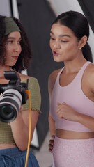 Poster - Choice, photographer and women with camera, creative and teamwork for photos in agency and talent. Photography, people and preparation for photoshoot in studio, backstage and decision for production
