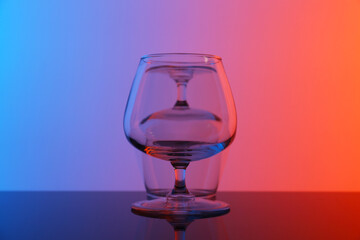 Sticker - Empty glasses on table against color background