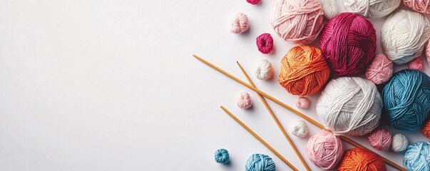 Poster - Colorful yarn balls and knitting needles lying on white desk creating a frame with copy space