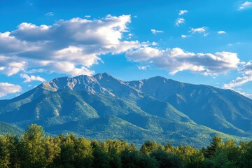 Fototapete - Majestic mountain range rising against a backdrop of soft clouds and blue sky with ample space for text. Generative AI