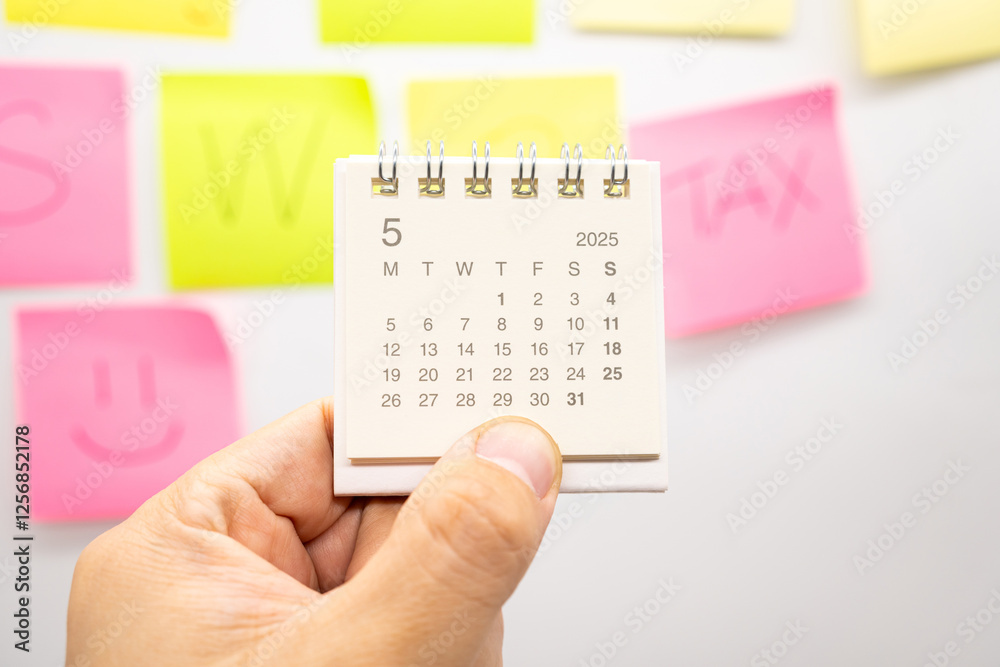 hand-holding-mini-calendar-for-may-2025-background-calendar-concept