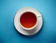 © Velocity - Teacup on soft blue surface Overhead perspective