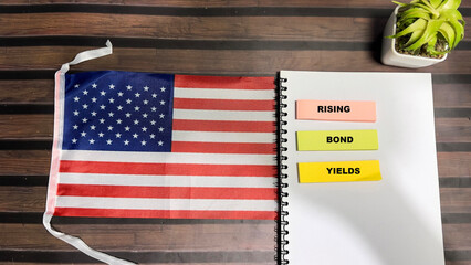 Wall Mural - Concept of Rising Bond Yields write on sticky notes and Flag of the United States isolated on Wooden Table.