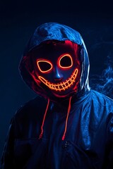 Poster - Person in a black hoodie is lit up by a vibrant orange led mask