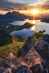 Wall Mural - A stunning sunrise over the serene Lake Panao, with mountains and lush greenery in the background, captured from atop Mount Samalayon's peak. 