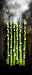 Canvas Print - Steaming asparagus on dark surface